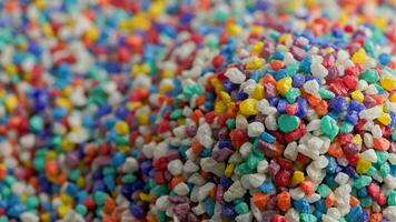 crushed colored stones heap slowly spinning, loopable closeup video