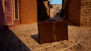 A piece of luggage sitting on a cobblestone street video