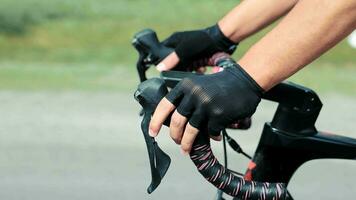 Cyclist's hands while riding a bicycle closeup side view. video