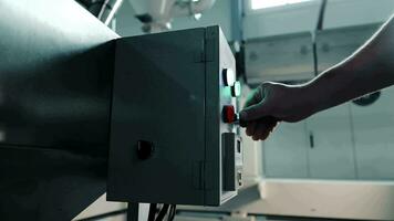 Startup of production equipment. Closeup of an engineer pressing a button on the control panel of a production machine. video