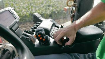 A man operates a combine harvester using the control panel. Harvesting agricultural video