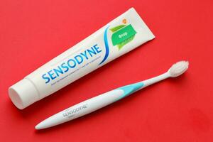 KYIV, UKRAINE - MAY 4, 2022 Sensodyne fluorine or fluor is a daily fluoride toothpaste photo