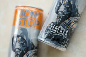 KYIV, UKRAINE - OCTOBER 31, 2023 Non Stop energy drink with limited edition design of Stalker and character with gas mask on aluminium tin can photo