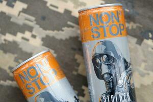 KYIV, UKRAINE - OCTOBER 31, 2023 Non Stop energy drink with limited edition design of Stalker and character with gas mask on aluminium tin can photo
