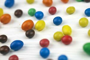 KHARKIV, UKRAINE - JANUARY 2, 2021 M and Ms colorful button shaped chocolate candies. Multi colored chocolates each of which has the letter m printed in lower case in white photo