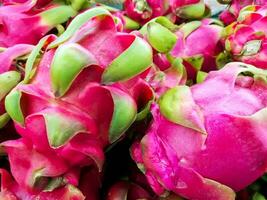 Closeup lots of dragon fruit sell in supermarket. photo