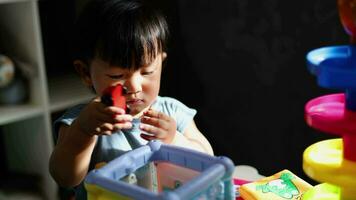 Kid playing with colorful toy blocks. Little boy building tower of block toys. Educational and creative toys and games for young children. Child at home. video