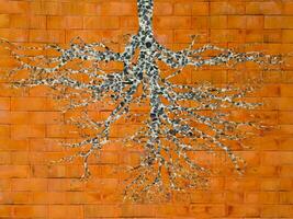 Roots stone on the orange brick wall. photo