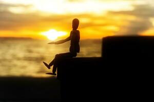 Silhouettes of wooden models feel lonely at sunset. photo