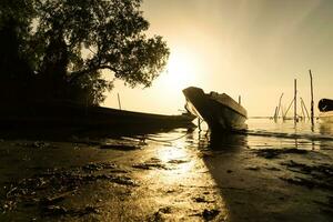 Local fishing boat morning light reflection. photo