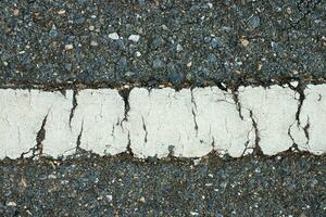 Old yellow traffic lines on the road. photo