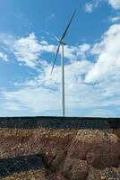 Layers of road with soil and rock under the wind turbine. photo