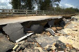 Road erosion caused by waves and severe storms. photo