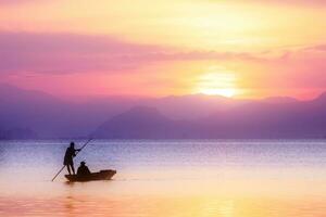 Beautiful sky and Silhouettes of Minimal fisherman at the lake in pastel color. photo