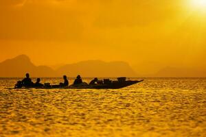 Silhouettes of Minimal fisherman at the lake, Thailand. photo