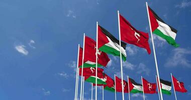 Isle of Man and Palestine Flags Waving Together in the Sky, Seamless Loop in Wind, Space on Left Side for Design or Information, 3D Rendering video