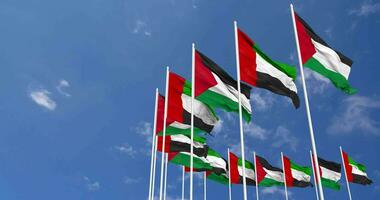 unido árabe emiratos y Palestina banderas ondulación juntos en el cielo, sin costura lazo en viento, espacio en izquierda lado para diseño o información, 3d representación video