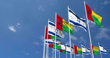 Guiné bissau e Israel bandeiras acenando juntos dentro a céu, desatado ciclo dentro vento, espaço em esquerda lado para Projeto ou Informação, 3d Renderização video