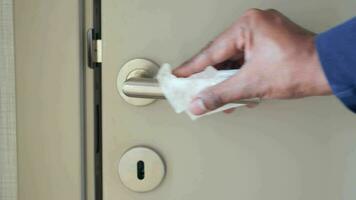 cleaning door knob with tissue close up video