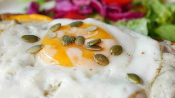 Fried eggs on served with green herbs video