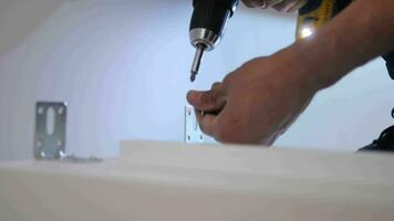 slow motion of using electric drilling on white wooden board video