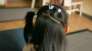 Beautiful ribbon is tied on a child hair video