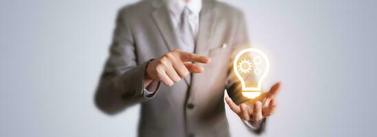 Business man with innovation digital light bulb gear icon. Business engineering idea background photo