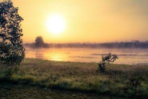 Sunrise at African savannah lake during camping adventure in Malawi photo