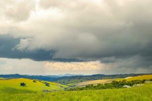 Dramatic landscape, rolling hills under thunderstorm clouds in Nyika National Park in Malawi, Africa photo