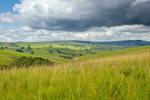 Dramatic landscape, rolling hills under thunderstorm clouds in Nyika National Park in Malawi, Africa photo