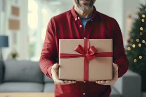 ai generado un hombre vistiendo un rojo t camisa y participación un regalo caja en contra un Navidad árbol foto