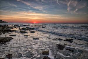 Beautiful sunrise over the sea with water motion blur photo