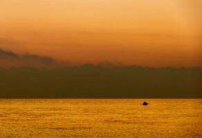 The anglers go fishing from a boat on a beautiful morning photo