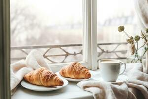 AI generated Cozy weekend vibes with steaming coffee, croissants, and a snowy window backdrop photo