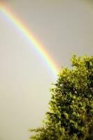 Rainbow against dark threatening sky photo