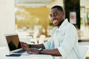 Man using handsome technology male person sitting office happy black work smiling african computer photo