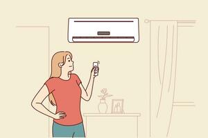 Woman turns on air conditioner standing in living room and uses remote control to set comfortable temperature. Happy girl rejoices at presence of modern air conditioner to combat summer heat vector