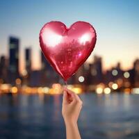 AI generated Hand holding heart-shaped balloon against blurred city lights photo