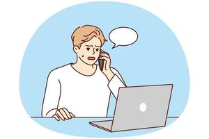 Angry young man sit at desk work on computer talk on cell about problem on device. Unhappy male experience trouble using laptop speak with helpline. Vector illustration.