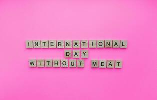 March 20, International Day Without Meat, a minimalistic banner with an inscription in wooden letters photo