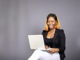 beautiful African lady using her laptop photo