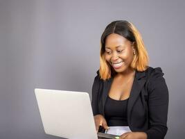 beautiful African lady using her laptop photo