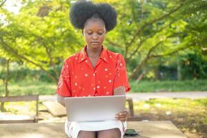 Teen girl studying with a laptop outdoor photo