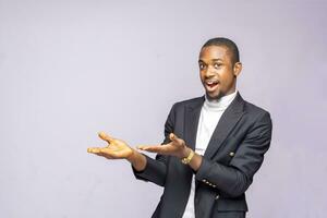 Businessman showing pointing on background. Very fresh and energetic beautiful black africa young Man smiling happy presenting on white background. photo