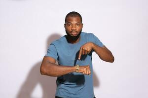 young black man eagerly pointing to his watch photo