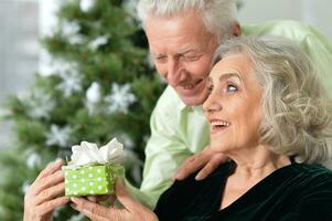 Happy elderly couple celebrating new year at home photo