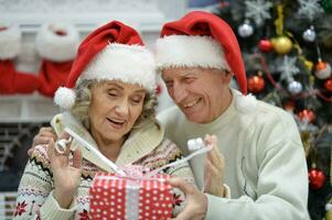 Happy elderly couple celebrating new year at home photo