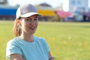 A young beautiful woman in sportswear plays sports at a local stadium photo