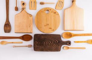 Beautiful kitchen background with wooden tool on a white table with a various cutting board in the center. Flat lay. Top view. space for text. photo