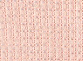 Beautiful lace cotton fabric in peach color. Layout for design. Abstract cotton texture background. The color of the year is peach fuzz. photo
